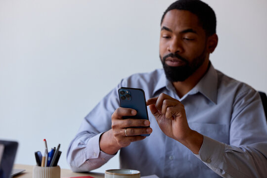 Portrait of a businessman types on his phone