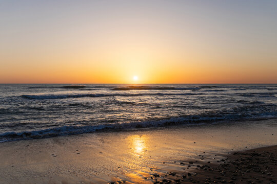 Sunset on the beach with a calm sea