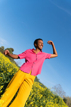 Happy man dancing field spring