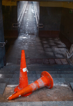 Orange Traffic Cones On Broken Stairs at Pedestrian City Tunnel