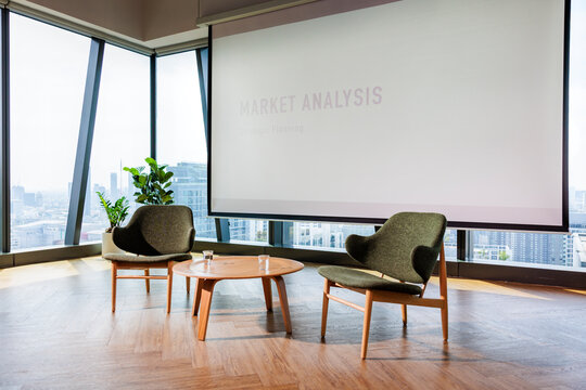 Modern office space with market analysis presentation and city view.