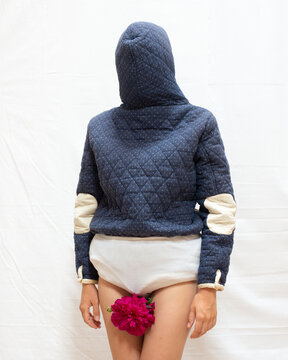 A woman wearing a coat backwards 13