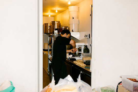 Chef weighing dough balls in a fine-dining restaurant kitchen
