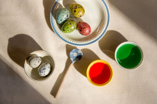 Colorful eggs and paints on a table during Easter 