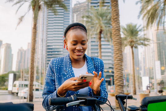 A woman pays for the rental of a scooter