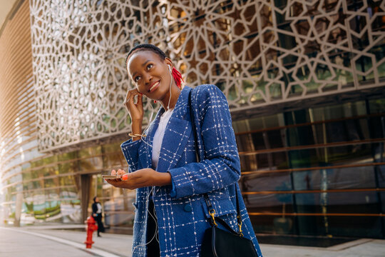 A woman putting on earphones