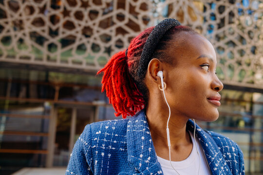 A woman with earphones in the city