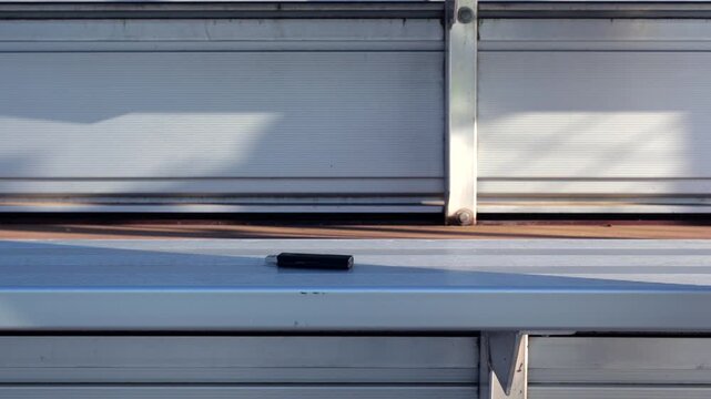 Unsuspecting man finds lost USB thumb drive on ground illustrating malicious USB drop attack - Cybersecurity Information Technology Concept