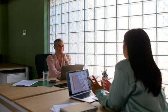 Colleagues talk to each other at the office