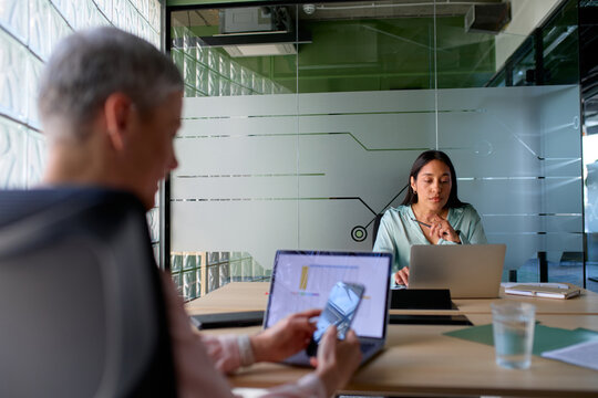 Colleagues talk to each other at the office