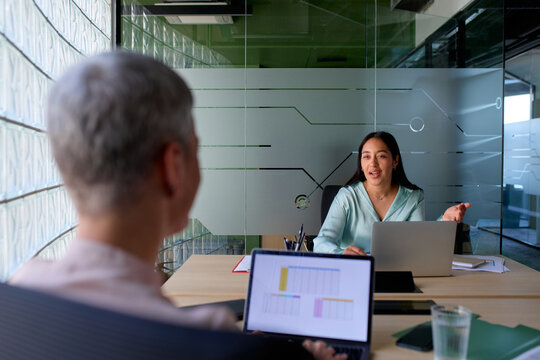 Colleagues talk to each other at the office