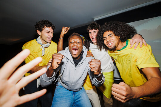 Diverse group of people cheering watching world cup game