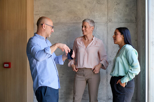 Small group of colleagues chat indoors