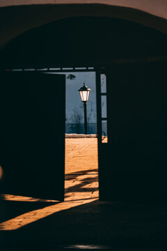 Light shining through an open door at dusk in a quiet setting