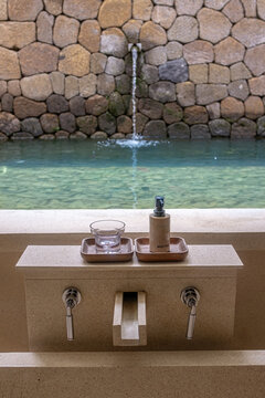 Luxury stone bathtub with water feature in spa bathroom
