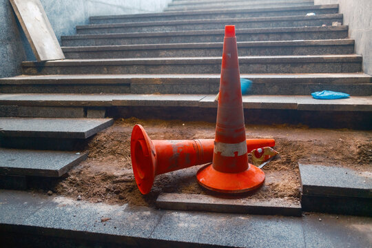Construction Work on City Stairs With Cones and Debris Present