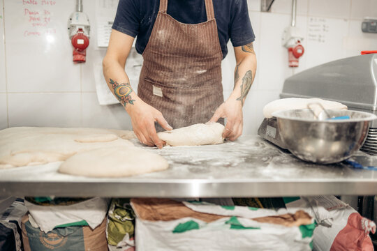 Baker preparing dough for fresh baked bread