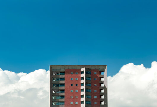 Minimalist Residential Tower Against a Vivid Blue Sky