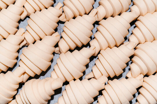 Puff paste croissants arranged ready for baking