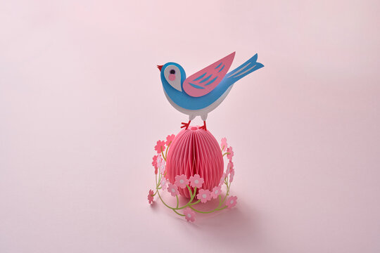 Paper spring craft bird on floral easter egg