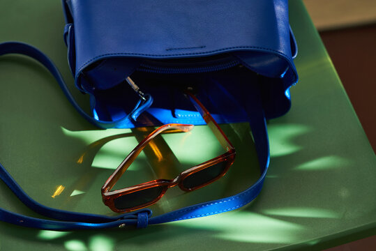 Bag and sunglasses illuminated with sunlight