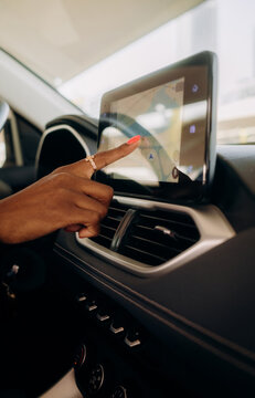 A woman using a multimedia display in a car