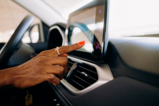 A woman using a multimedia display in a car