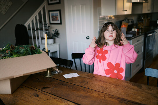 little girl getting ready to make a wreath in her kitchen dining area