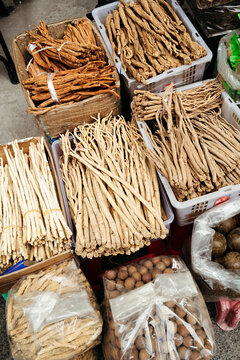 Herbs and Roots in Vibrant Market Stalls of Traditional Herbalists