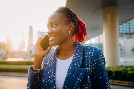A woman is talking on her mobile phone in the city