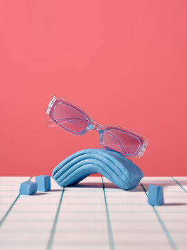 Stylish blue translucent sunglasses resting on a blue clay shape
