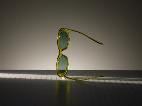 Stylish yellow sunglasses with green lenses