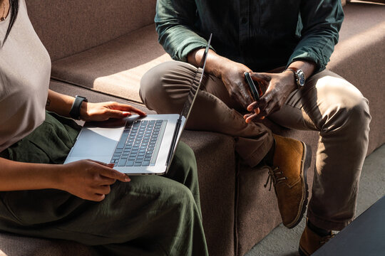 Anonymous People Casual Business Meeting With Laptop And Phone