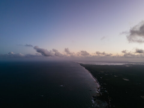 Sunset coastline with soft clouds and fading light