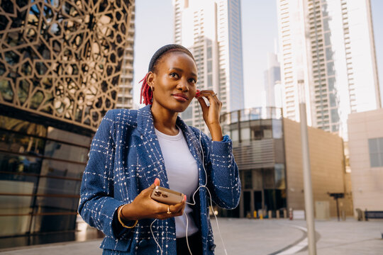A woman putting on earphones