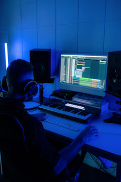 Music Producer Creates Beats in Home Studio at Night