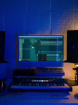 Music Studio Setup With Computer Screen and Keyboard at Night