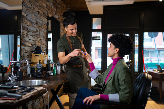 Barber and customer share a moment in a shop