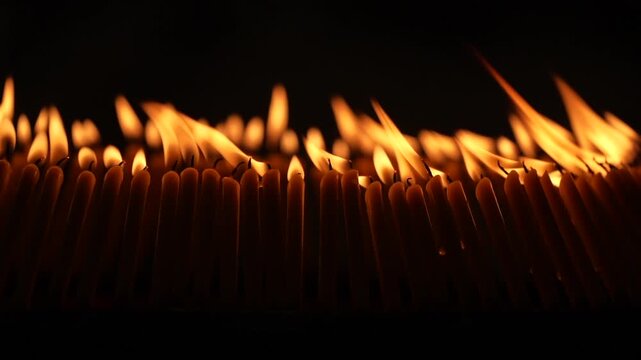 Rows of warm candle flames in a dark temple setting create a sacred visual composition with glowing light, soft smoke, and peaceful Buddhist worship atmosphere.