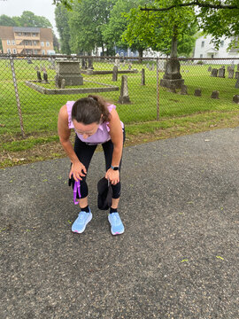 exhausted middle aged woman after completing running race