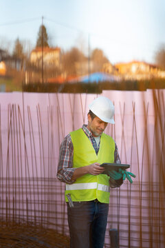 Worker checks data on tablet at construction site