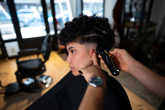 Client getting a haircut in a barbershop