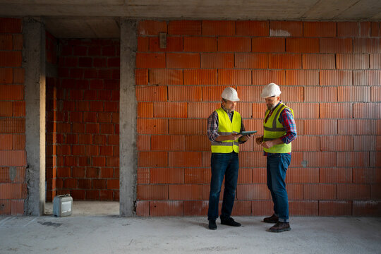 Workers discuss project details on site