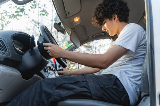 Young man learning to drive shifting gears