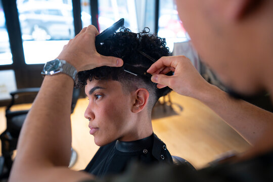 Styling hair at a barbershop in the afternoon