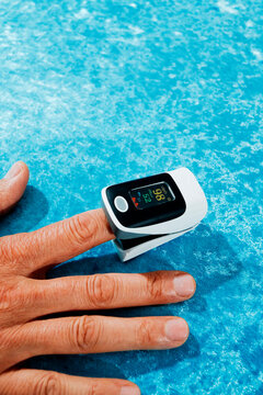 a pulse oximeter clipped onto a finger of a man