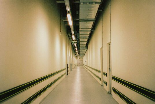 Long empty hallway with warm toned walls