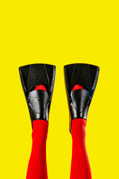 the lower legs of a man in red socks wear diving fins