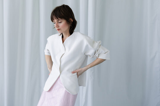 Short Hair Elegant White Blazer Pink Skirt Hands on Waist Shy Gaze