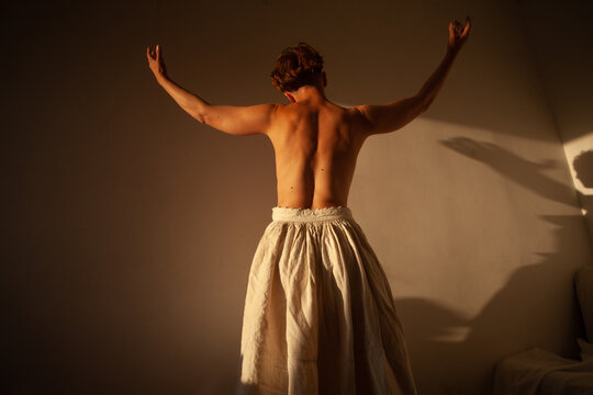 A woman in the warm sunlight in her room 